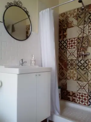 a bathroom with a sink and a mirror and a tub at Casa Ribeira Sacra Portomarin in Portomarin