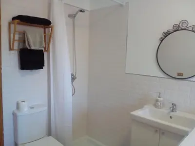 a bathroom with a toilet and a sink and a mirror at Casa Ribeira Sacra Portomarin in Portomarin