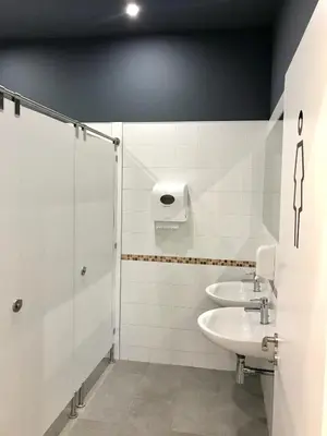 a bathroom with two sinks and a shower at Albergue O Burgo in O Pedrouzo