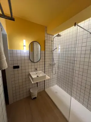 a bathroom with a sink and a shower at Albergue O Burgo in O Pedrouzo