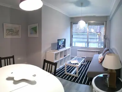 a living room with a couch and a table at Torre Center in Santiago de Compostela