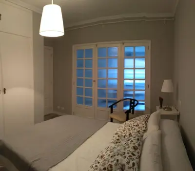 a bedroom with a bed and a large window at Torre Center in Santiago de Compostela