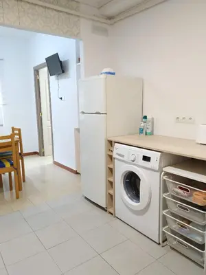 a kitchen with a white refrigerator and a washing machine at Apartamento Casco Antiguo Ponferrada in Ponferrada