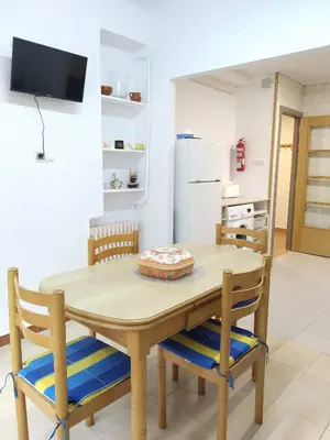 a kitchen with a wooden table and chairs at Apartamento Casco Antiguo Ponferrada in Ponferrada