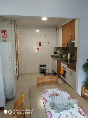 a kitchen with a table and a dining room at Apartamento Casco Antiguo Ponferrada in Ponferrada