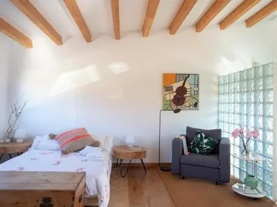 a bedroom with a bed and a chair at Casa Lourido in Sada