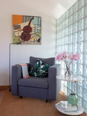 a living room with a blue chair and a table at Casa Lourido in Sada