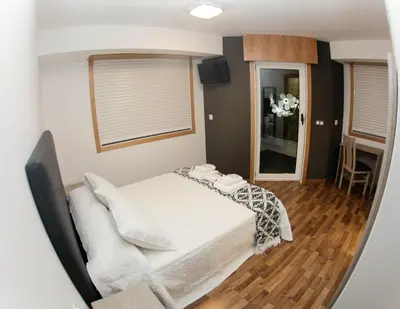 a bedroom with a white bed in a room at Pension Esquina in Melide