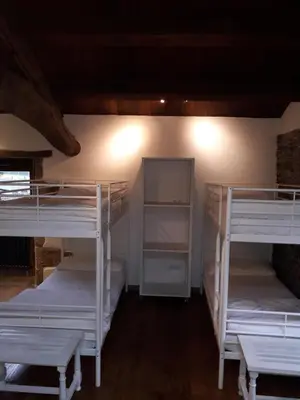a room with several bunk beds in a room at Albergue o Xistral in Abadín