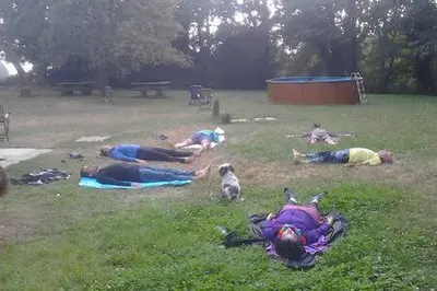 a group of people laying on the grass in a park at Albergue o Xistral in Abadín