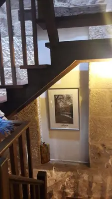 a staircase in a house with a picture on the wall at A Lareira De Allariz in Allariz
