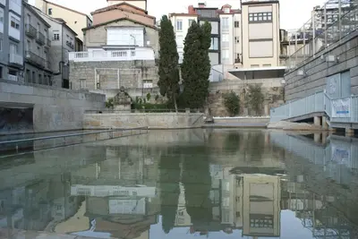 a person standing in a body of water at A Lareira De Allariz in Allariz