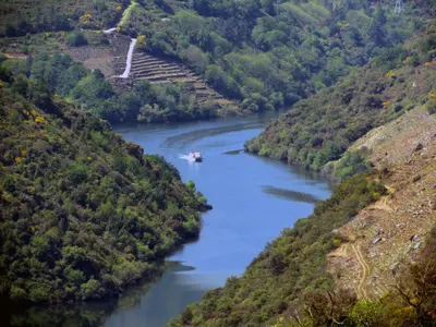 a boat on a river in a valley at A Lareira De Allariz in Allariz