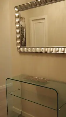 a glass table in front of a mirror at Ourense Termal in Ourense