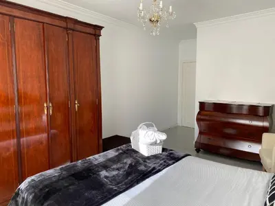 a bedroom with a bed and a dresser at Ourense Termal in Ourense