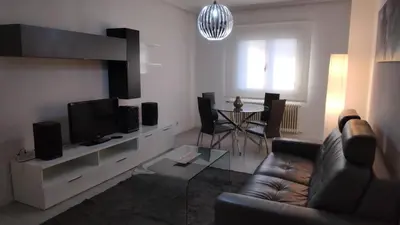 a living room with a couch and a television at Ourense Termal in Ourense