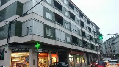 a green traffic light in front of a building at Ourense Termal in Ourense
