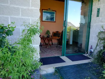 a glass door of a house with a table at O ollo do Mar in Viveiro
