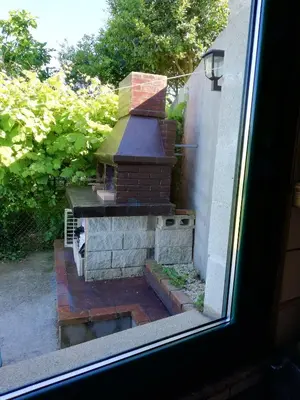 a view of a brick grill from a window at O ollo do Mar in Viveiro