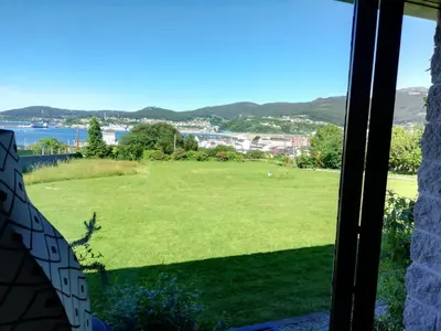 a view from a window of a green field at O ollo do Mar in Viveiro