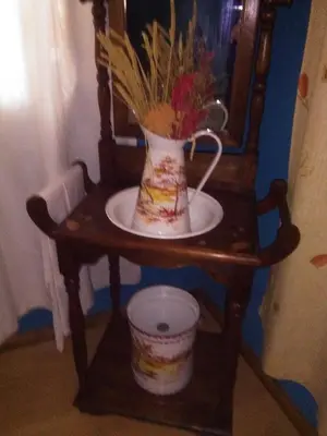 a table with a vase with flowers on it at Casa Rural Calecha in Caboalles de Abajo