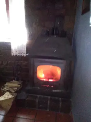 a brick oven with a fire inside of it at Casa Rural Calecha in Caboalles de Abajo