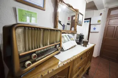 a dressing room with a mirror and a wooden dresser at Casa Rural Calecha in Caboalles de Abajo