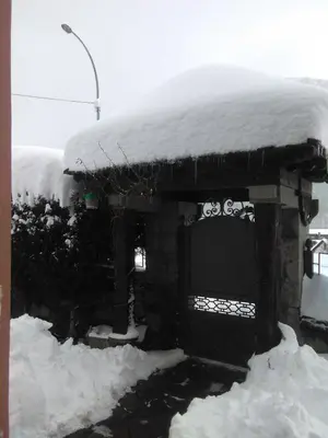 a building with snow on the top of it at Casa Rural Calecha in Caboalles de Abajo