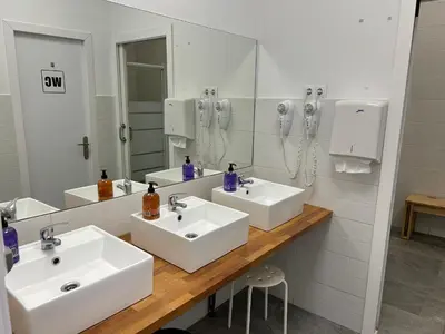 a bathroom with two sinks and a mirror at Albergue SCQ in Santiago de Compostela