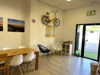 a room with a table and a bike hanging on the wall at Albergue SCQ in Santiago de Compostela