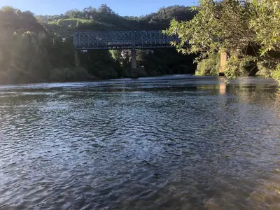 a bridge over a river with a body of water at Casa Alpargateiro in Os Peares