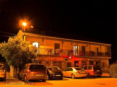 a group of cars parked in front of a building at Cornatel Médulas in Borrenes