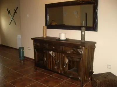 a room with a wooden dresser with a mirror at Cornatel Médulas in Borrenes