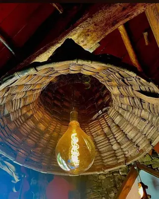 a yellow light is hanging from a basket at Cornatel Médulas in Borrenes
