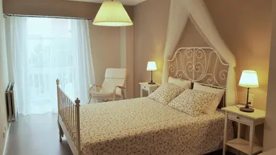 a bedroom with a bed and a window and a lamp at Apartamento DACTONIUM - Ribeira Sacra in Monforte de Lemos