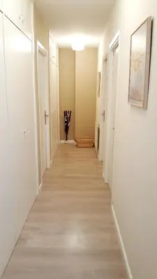 a long hallway with white walls and wood floors at Apartamento DACTONIUM - Ribeira Sacra in Monforte de Lemos