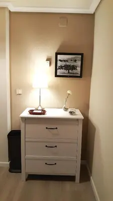 a room with a dresser with a lamp on it at Apartamento DACTONIUM - Ribeira Sacra in Monforte de Lemos