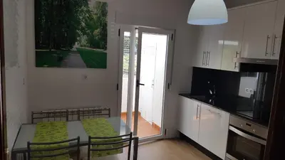 a kitchen with a table and chairs and a kitchen with a window at La Casita de Plata in Monforte de Lemos