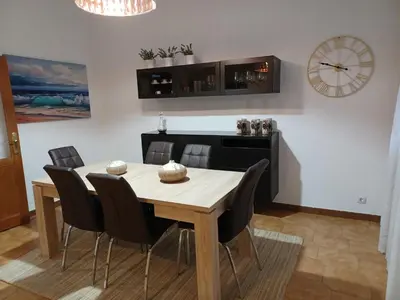a dining room with a wooden table and chairs at La Casita de Plata in Monforte de Lemos
