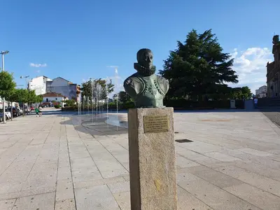a statue of a woman on aolith in a plaza at La Casita de Plata in Monforte de Lemos
