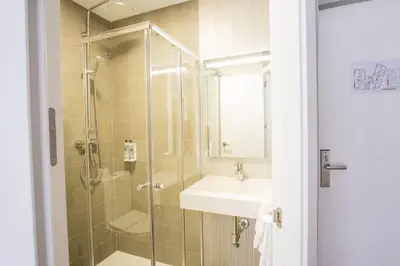 a bathroom with a shower and a sink and a toilet at Hotel Alda Centro Ponferrada in Ponferrada