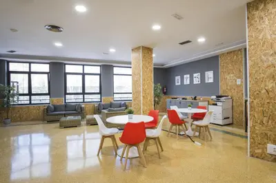 an office lobby with a table and chairs at Hotel Alda Centro Ponferrada in Ponferrada