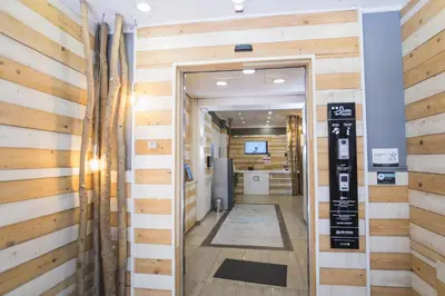 a hallway with wood paneled walls and a door at Hotel Alda Centro Ponferrada in Ponferrada