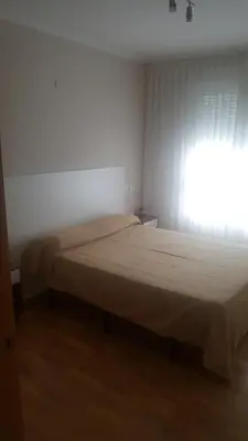 a bedroom with a bed and a window with curtains at Costa do Castro in Foz