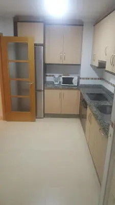 a small kitchen with a refrigerator and a stove at Costa do Castro in Foz
