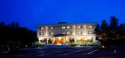 a building with a parking lot in front of it at Hotel Os Olivos in Guísamo