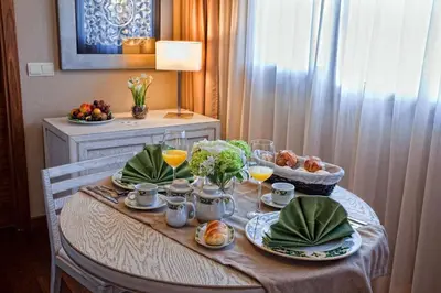 a table with plates of food and drinks on it at Hotel Os Olivos in Guísamo