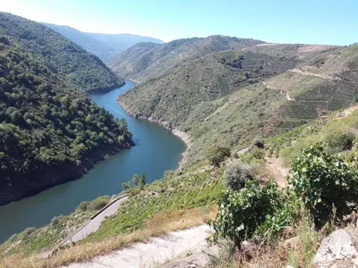 a view of a river in a valley at casa do peso in Monforte de Lemos