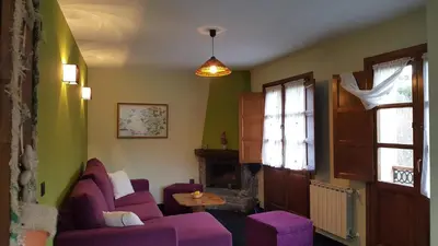 a living room with a purple couch and a window at Apartamentos El Valledor in Tremado