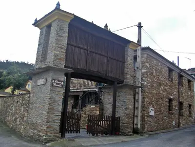 an old stone building with a wooden roof at Casa Benito in Ribadeo